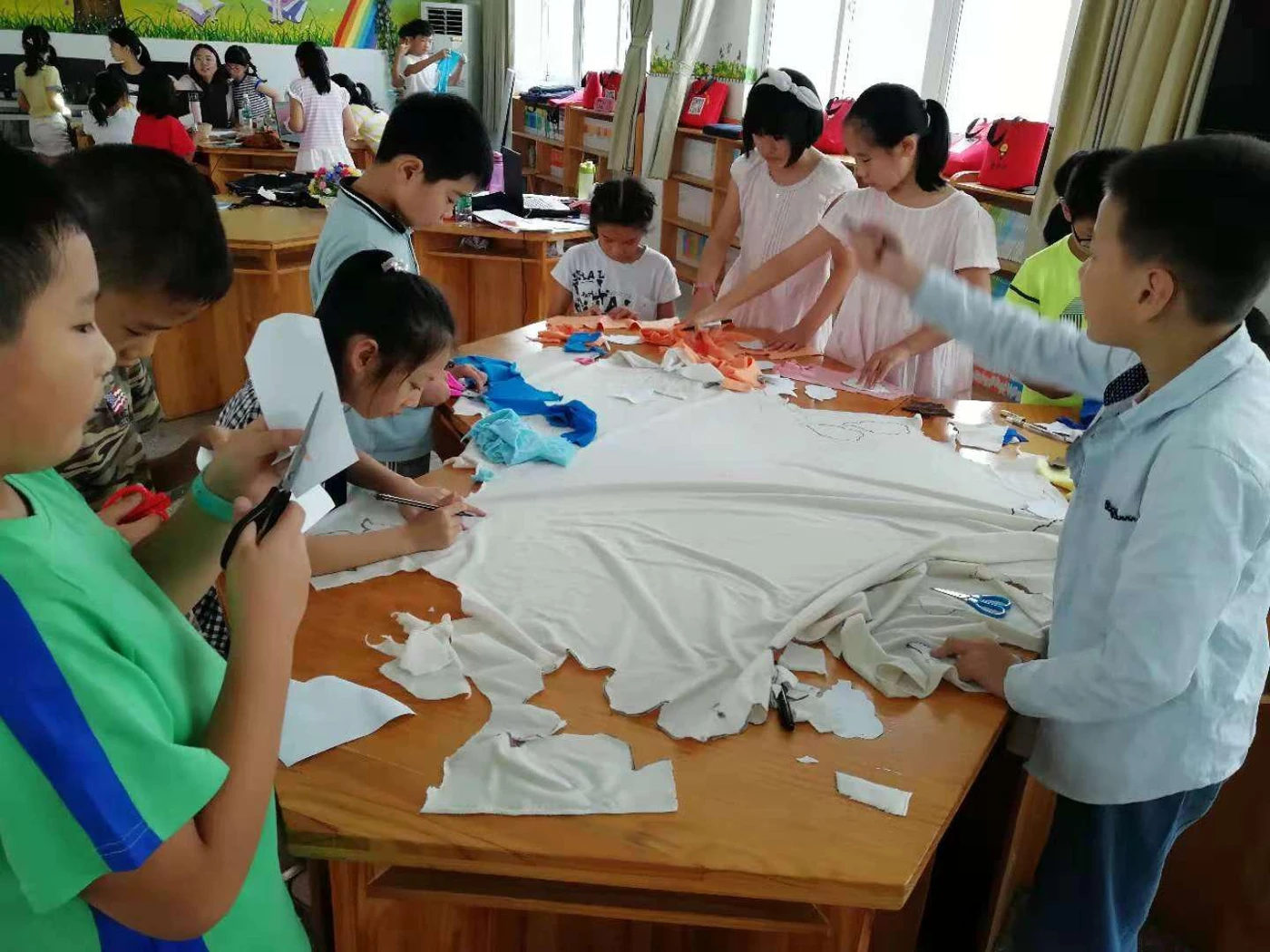 Children learning to work with fabric patterns in a classroom